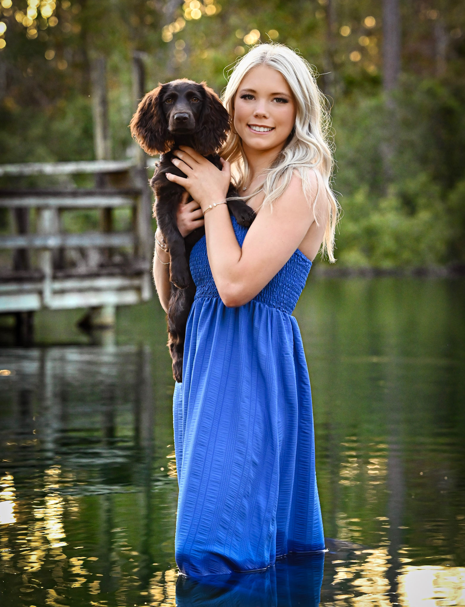 Hannah Kurrasch, ABAT at Imago Dei Therapeutic Services, holding her dog outdoors